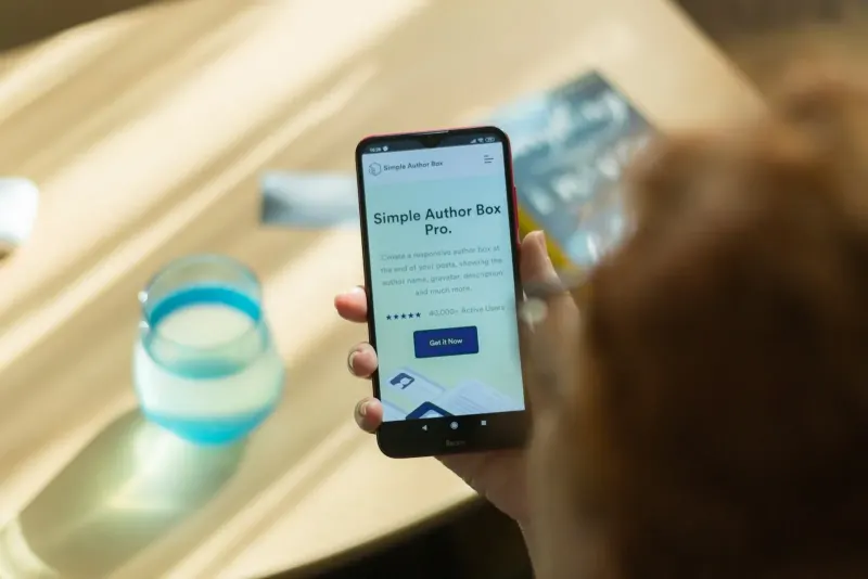 Person holding a smartphone showing a website