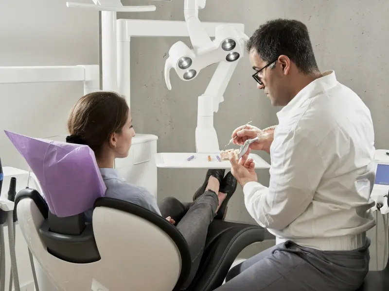 Man in a white shirt sitting on an office chair