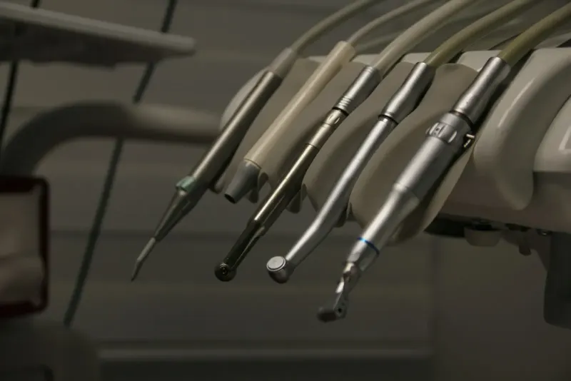 Row of dental instruments hanging on a wall