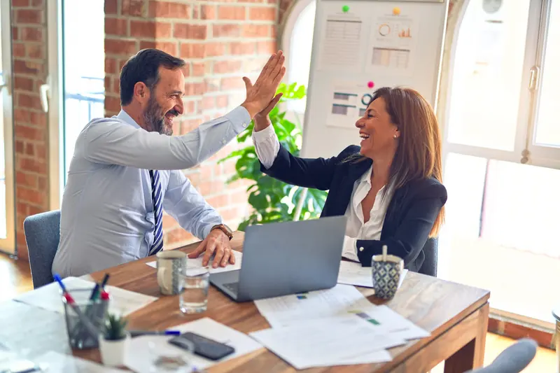 Website developer celebrating with a client
