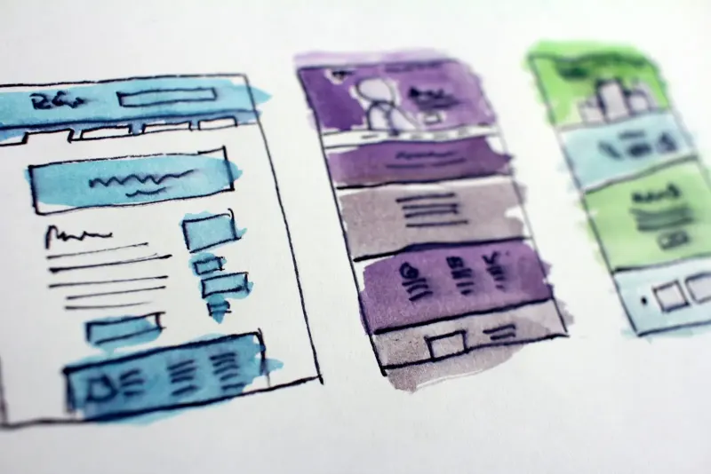 Watercolour wireframe sketches of website layouts