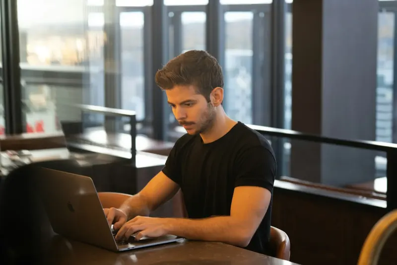 Man using a MacBook at a desk